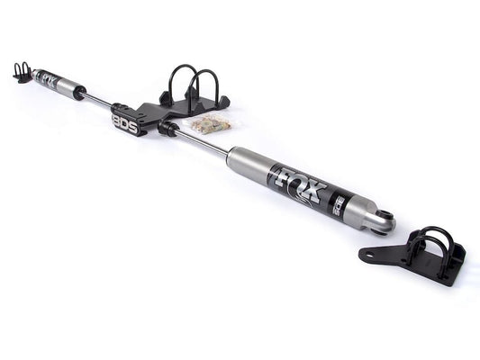Hands installing steering stabilizer on lifted F-250